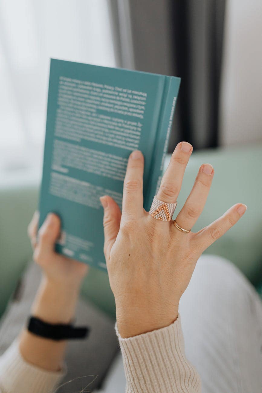 a person reading the back cover of a book